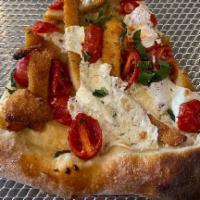 Chicken Bruschetta Pizza · Breaded chicken cutlet topped with fresh mozzarella, diced cherry tomato salad, and a sun dr...