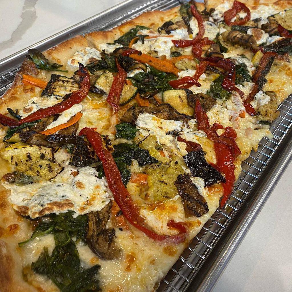 Vegetable Primavera Pizza · Grilled eggplant, zucchini, and yellow squash topped with fresh spinach, roasted peppers, and mozzarella.