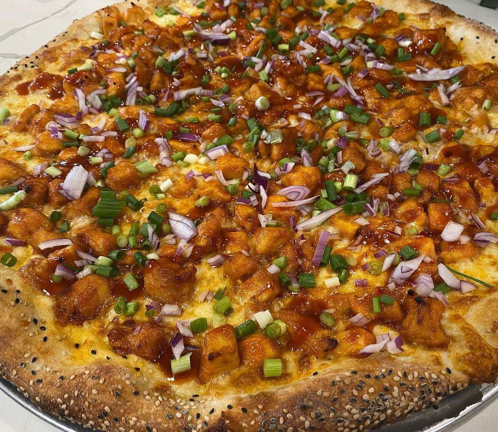 Korean BBQ Pizza · Gochujang style with sweet chili chicken. Marinated diced chicken tossed in our homemade sweet and spicy Korean style BBQ sauce topped with diced red onion and scallions.