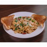 Zydeco Pasta · Shrimp, sausage, and Cajun cream sauce over bowtie pasta. Sprinkled with Green Onions and se...