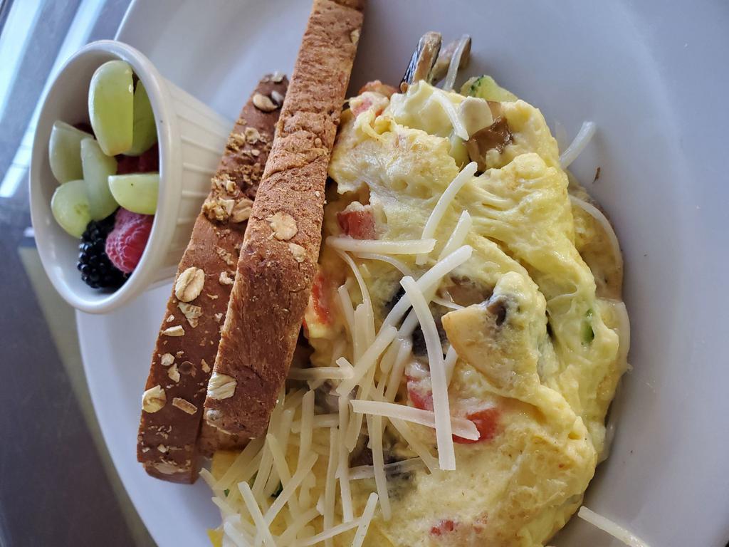 Farmer's Market Omelette · Three egg omelette with mushrooms, yellow squash, zucchini, red bell peppers, and Parmesan cheese. Served with toast and a small side of fruit. Add-ons for an additional charge.