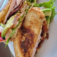 Southwestern Club Sandwich · Smoked turkey, avocado, bacon, chipotle mayonnaise, lettuce and tomato on toasted bread. 