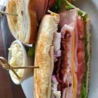 Classic Club Sandwich · Smoked turkey, ham, swiss and cheddar cheeses, bacon, lettuce, onions, tomatoes, toasted bre...