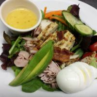 Cobb Salad · Mixed greens with diced ham, hard-boiled eggs, olives, capers, tomatoes, chicken, cucumbers,...