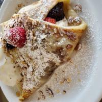 Fresh Fruit Crêpe · Cream cheese-filled crepe with seasonal fruit sprinkled with powdered sugar and toasted almo...