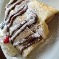 Nutella Banana Crêpe · Hazelnut chocolate with slices of banana, topped with powdered sugar. Whipped cream served o...