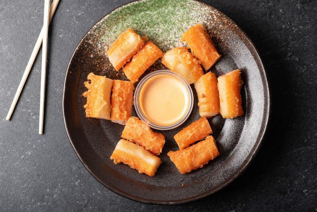 Kani Poppers · Mini kani pieces, tempura battered and deep-fried drizzled with sweet sauce.