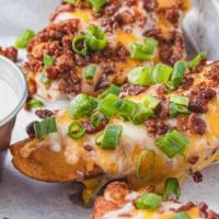 Potato Skins · Baked potato skins, topped with cheddar cheese, bacon, green onions, and served with sour cr...