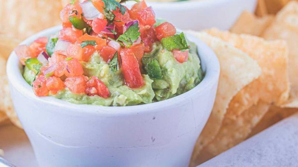 Triple Dip · House-made guacamole, house-made salsa, and house-made queso served with fresh tortilla chips or cracklins.