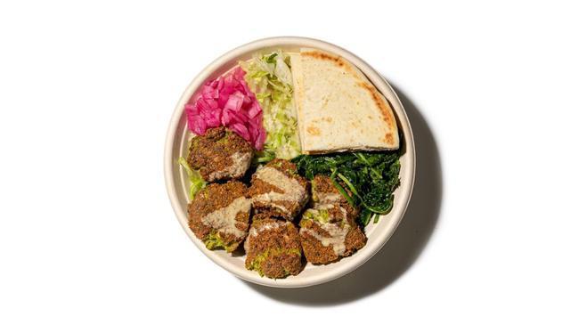 Salad Falafel · Authentic, Plant Based Falafel made w/ chickpeas, parsley, onions, cilantro, serrano peppers, garlic & tahini served over Green Blast® (kale, spinach, tossed in homemade cilantro lime dressing) and lettuce, topped with pickled onions & slice of pita bread (Note: pita bread contains gluten)