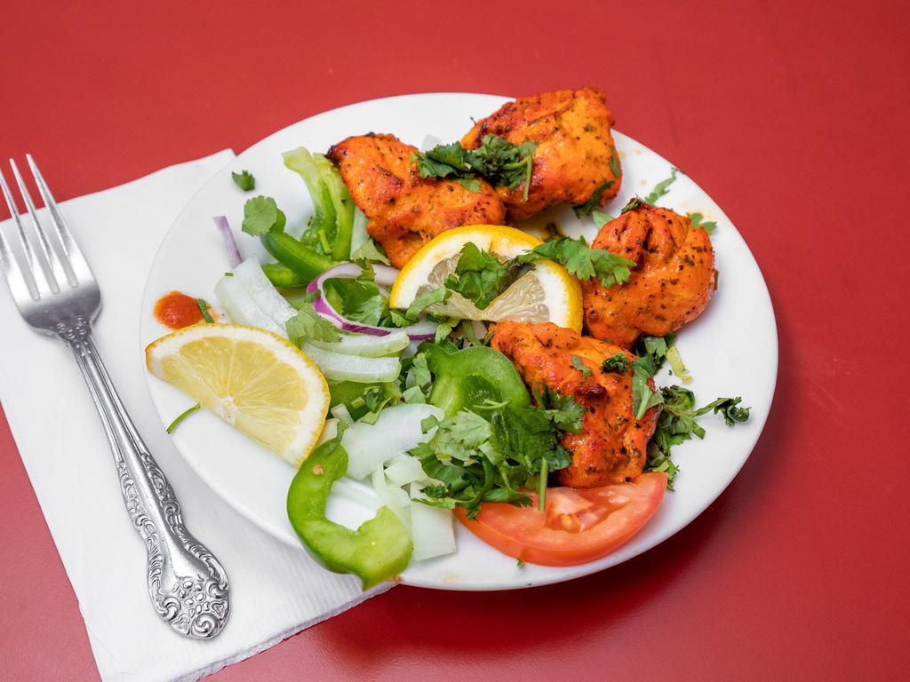 37. Chicken Tikka (Appetizer) · Marinated boneless chicken cooked in the clay oven.