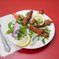 103. Lamb Seekh Kebab · Ground lamb flavored with herbs and spices and cooked in clay oven. Cooked 