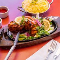 100. Chicken Tandoori · Marinated chicken breast flavored with herbs and spices and cooked in clay oven. 