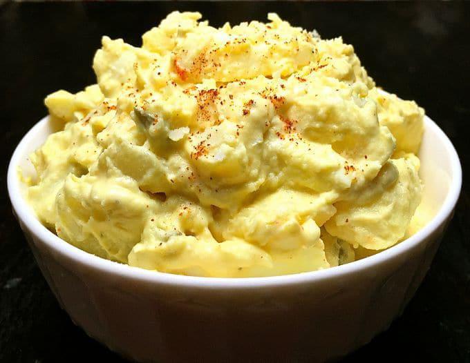 Potato Salad · Country style scratch made red potato salad, dressed with a peppery and pickle-y mayo and Dijon mustard sauce and topped with a dusting of smoked paprika.