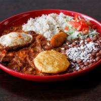 Bistec a la Criolla · Marinated steak with spices, tomatoes and red onions. Served with arepa, sweet plantains, fr...