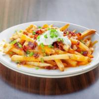 Irish Nachos · French fries topped with cheddar cheese, bacon, green onions, and sour cream.