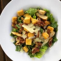 Caesar Salad · Crisp romaine lettuce with Caesar dressing, Parmesan cheese, bacon, and seasoned croutons.