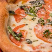 Margherita Pizza · Olive oil, tomatoes, fresh basil, spices, Parmesan and mozzarella cheese.