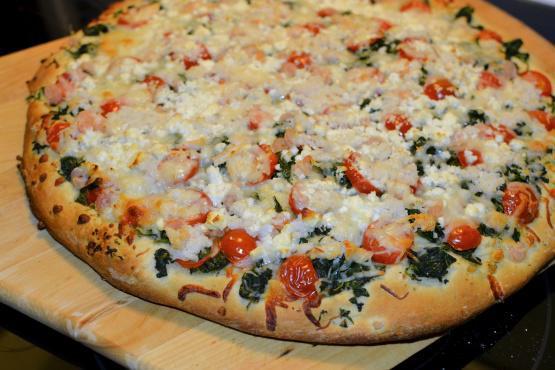 Spinach and Garlic Pizza · Olive oil, spinach, tomatoes, fresh garlic, feta and mozzarella cheese.