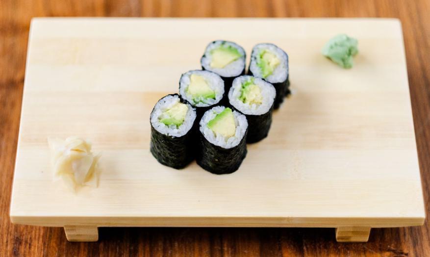Avo Maki Roll · Nori seaweed on the outside, seasoned rice, avocado and yuzu kosho inside.
