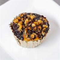 Mini Turtle Cheesecake cupcake ·  Decadent miniature cheesecake topped walnuts and pecans drizzled with dark chocolate and ca...