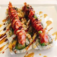 Dragon Maki · Shrimp tempura, lettuce, sesame, unagi sauce, spicy ahi, green onion, spicy sauce. Spicy.