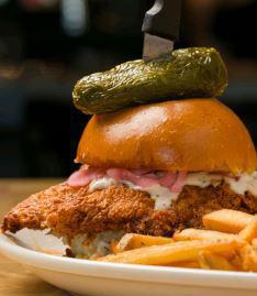 Nashville Screamin' Hot Chicken Sandwich · Buttermilk fried chicken breast doused in Nashville sauce and loaded with jalapeno slaw, ranch dressing and pickled red onions on a brioche bun, finished with a fried whole jalapeno and served with french fries.
