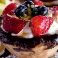 Large Fruit Tarte · Baked pastry filled with pastry cream and berries on top. 