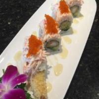 Snow Mountain Maki · Crabmeat, shrimp tempura with avocado and tobiko topped with scallions and coconut sauce.