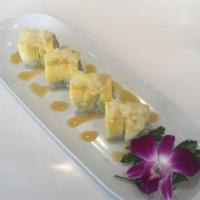 Tropical Maki · Crabmeat, shrimp and tempura flakes wrapped with mango. Topped with pineapple and mango sauce.