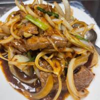 Mongolian Beef · Stir-fried shredded beef with scallions and onions. Finished with brown sauce. Hot and spicy.