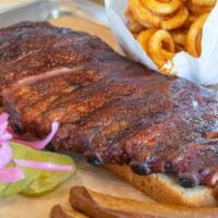 Smoked Pork Ribs (1/2 Slab) · 1/2 slab of st louis-style pork ribs. served with pickles, texas toast & choice of one hot o...