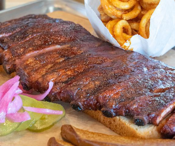 Smoked Pork Ribs (1/2 Slab) · 1/2 slab of st louis-style pork ribs. served with pickles, texas toast & choice of one hot or cold side, and Whomp! sauce.