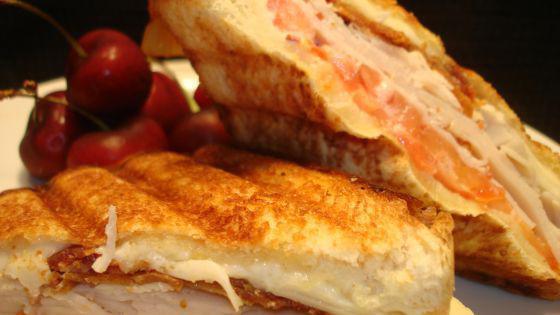 Turkey Club Panini · Mesquite smoked turkey, ham, smoked bacon, sharp cheddar cheese & brown mustard.