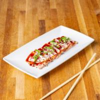 Tuna Tataki Plate · Seared sesame, crusted saku tuna with ginger-ponzu sauce. 