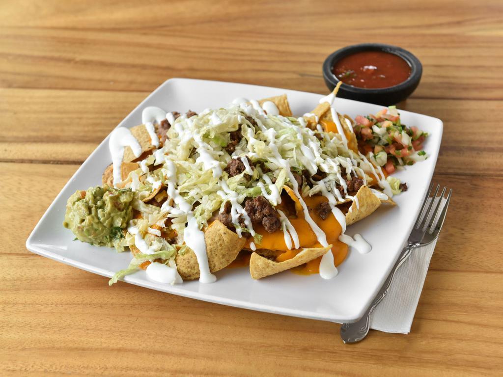 Nachos · Corn chips covered with cheese, sauce, beans, lettuce, jalapenos, guacamole, pico de gallo and sour cream.