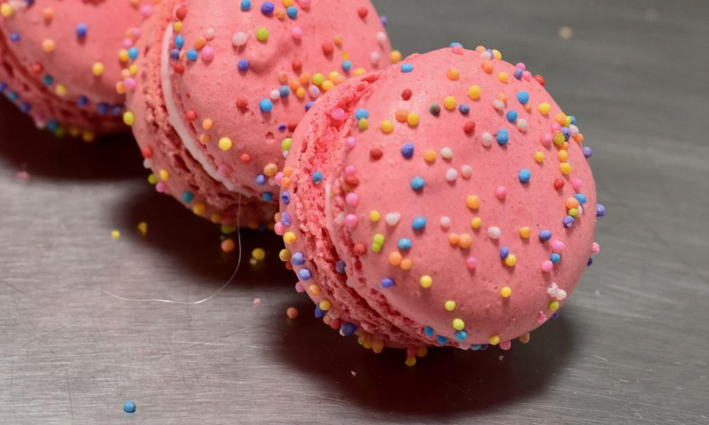 Princess Birthday Cake Macaron · A strawberry shell with pink strawberry bubblegum filling and round sprinkles on top.