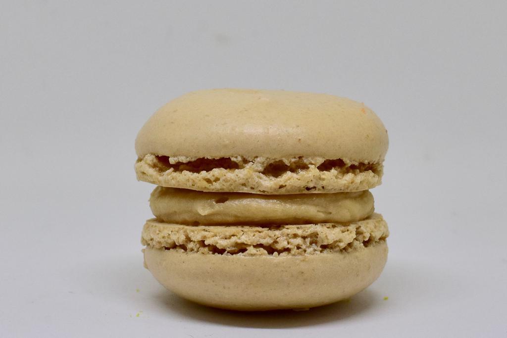 Coffee Milk Macaron · A coffee flavored macaron shell with a milk and coffee flavored buttercream filling.