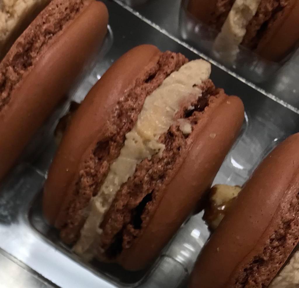 Snickers Bar Macaron · A chocolate shell with a chunk of Snickers on top and a Snickers/Caramel buttercream filling.