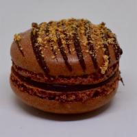 Butterfinger Macaron · Chocolate shells with Butterfinger sprinkles and a Butterfingers buttercream.
