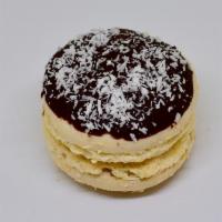 Almond Joy Macaron · An almond and coconut flavored macaron shell with both a swirl of dark chocolate ganache and...