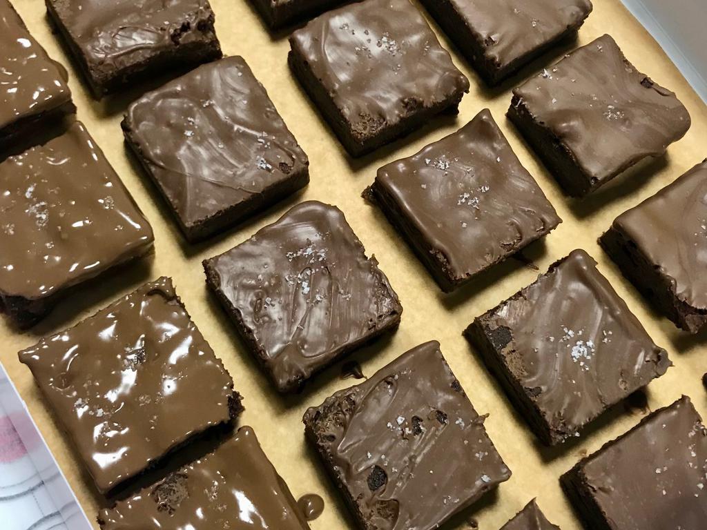 Peanut Butter Cup Brownie · Attention peanut butter and chocolate lovers!! This is your brownie!! This brownie is moist and chewy in the center with Reeses’ peanut butter cups baked right in! We have a small cult following on these brownies. They’re that good.