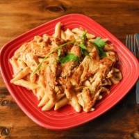 Sonora Chicken Pasta · Penne pasta tossed with sauteed onions, mushrooms and tomatoes in a creamy cheese sauce topp...