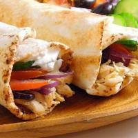 Chicken Shawarma Wrap · Marinated roasted chicken, tahini sauce, tomatoes, pickles and lettuce.