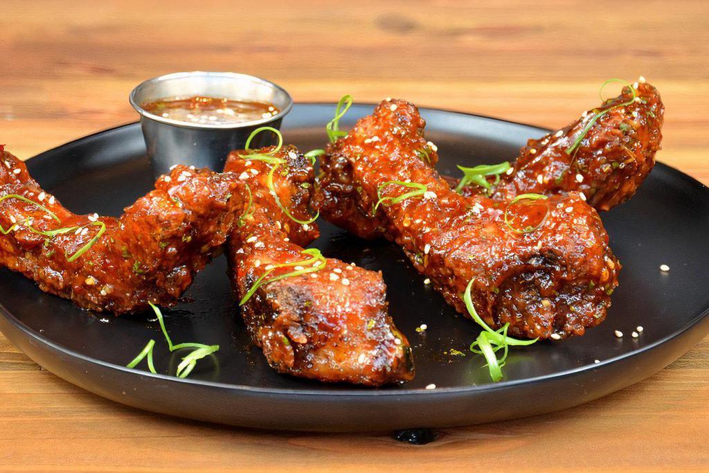 Thai Crispy Ribs · Lightly battered, crispy fried tender baby back ribs smothered in Thai BBQ sauce, topped with sesame seeds 