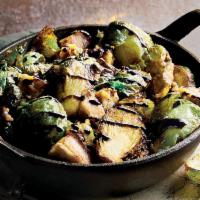 Crispy Brussels Sprouts · Fresh brussels sprouts deep fried crisp, topped with a balsamic glaze and Parmesan cheese