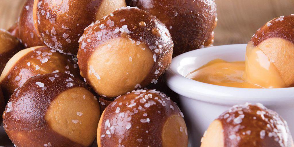 Pretzel Bites · Baked to perfection and served with queso
