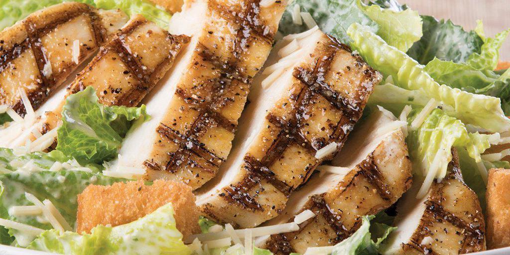 Grilled Chicken Caesar Salad · Grilled chicken, romaine lettuce, Parmesan cheese and croutons tossed with Caesar dressing 
