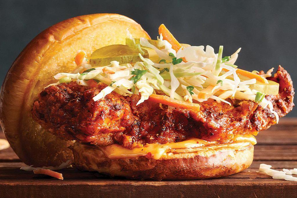 Nashville Hot Chicken Sandwich  · Crispy Nashville-style hot chicken breast topped with dill pickles, creamy coleslaw and spicy aioli
