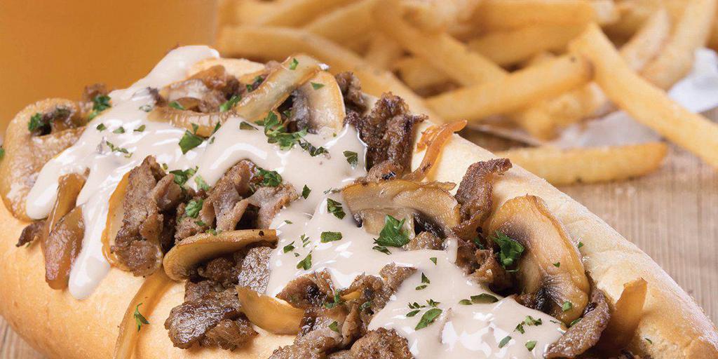The Republic Philly · Grilled sirloin, caramelized onions and mushrooms, chipotle mayo and Voodoo Ranger Queso inside a traditional hoagie 
